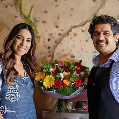 floristeria ambato dos personas sostienen un ramo de flores variadas en una floreria en Ambato